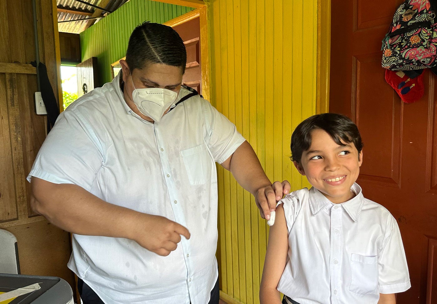 Jacinto Arroyo, primary care technical assistant (PCTA), administers the vaccine.