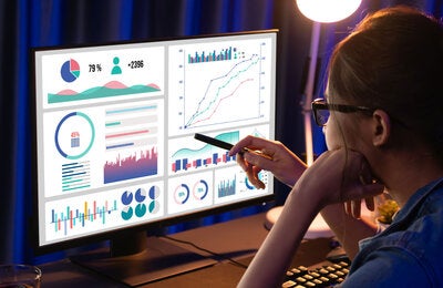 Woman performing data analysis on a computer