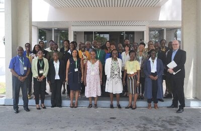 Photo of the group of participants on the workshop on QualityRights, shown standing in three rows at the door of a building