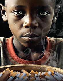 Kid Afrodescendant with a bowl full of tobacco products instead of food in front of him