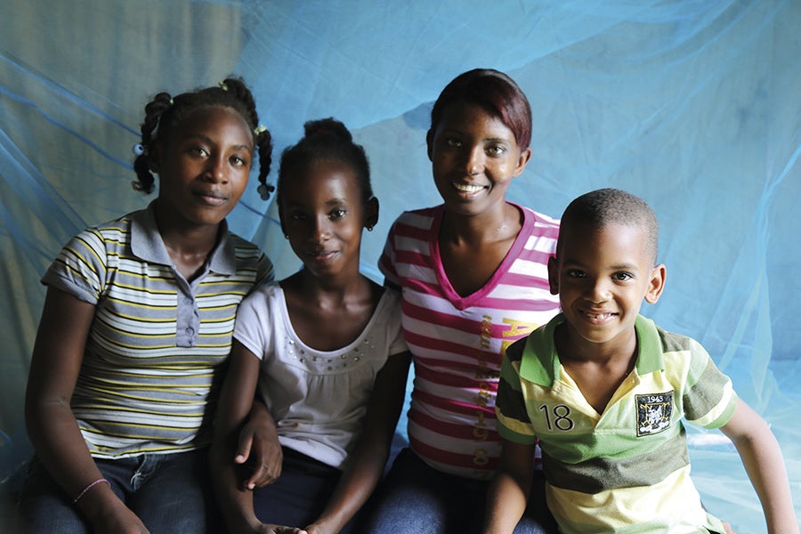 Group of young girls and a boy smiling.