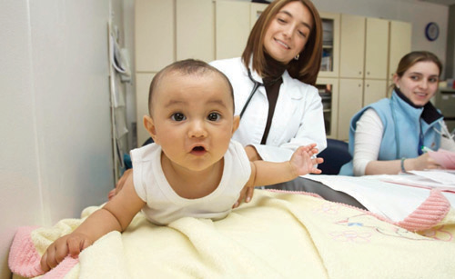Baby being examined by physician