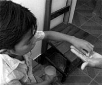Boy taking his anti-malarial medicines