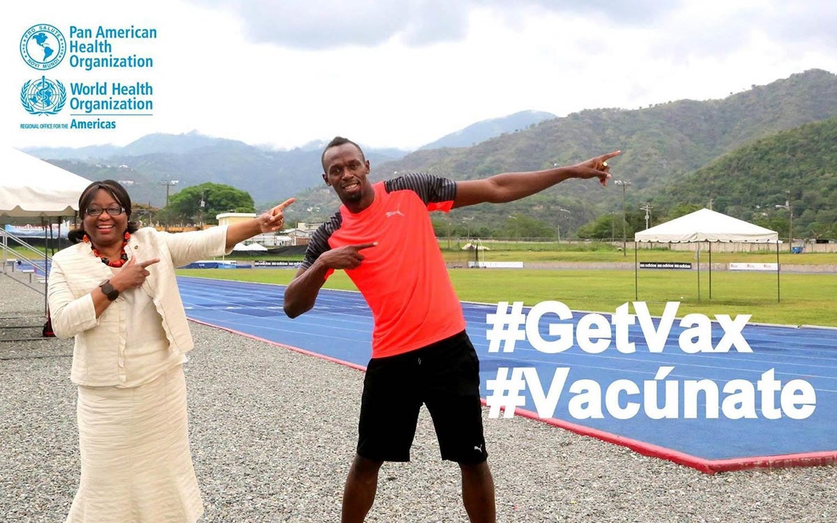 usain bolt and dr etienne posing for vax