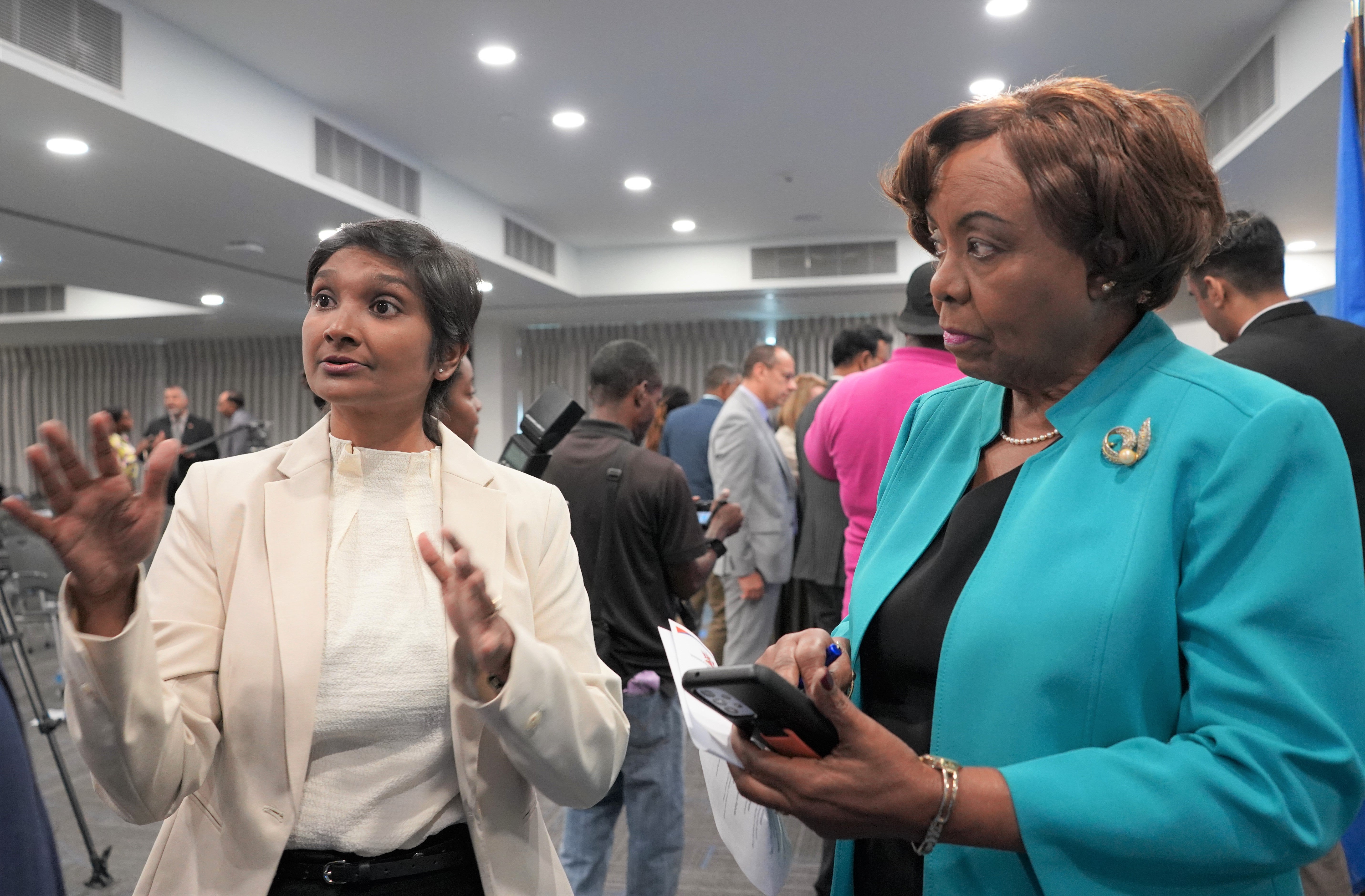 Mrs. Valerie Alleyne-Rawlins, Chairman of the South-West Reginal Health Authority listens intently as Dr Nadine Sangster, Professor and Programme Leader, MME, University of Trinidad and Tobago explains the functionality of the Health Service Robots.
