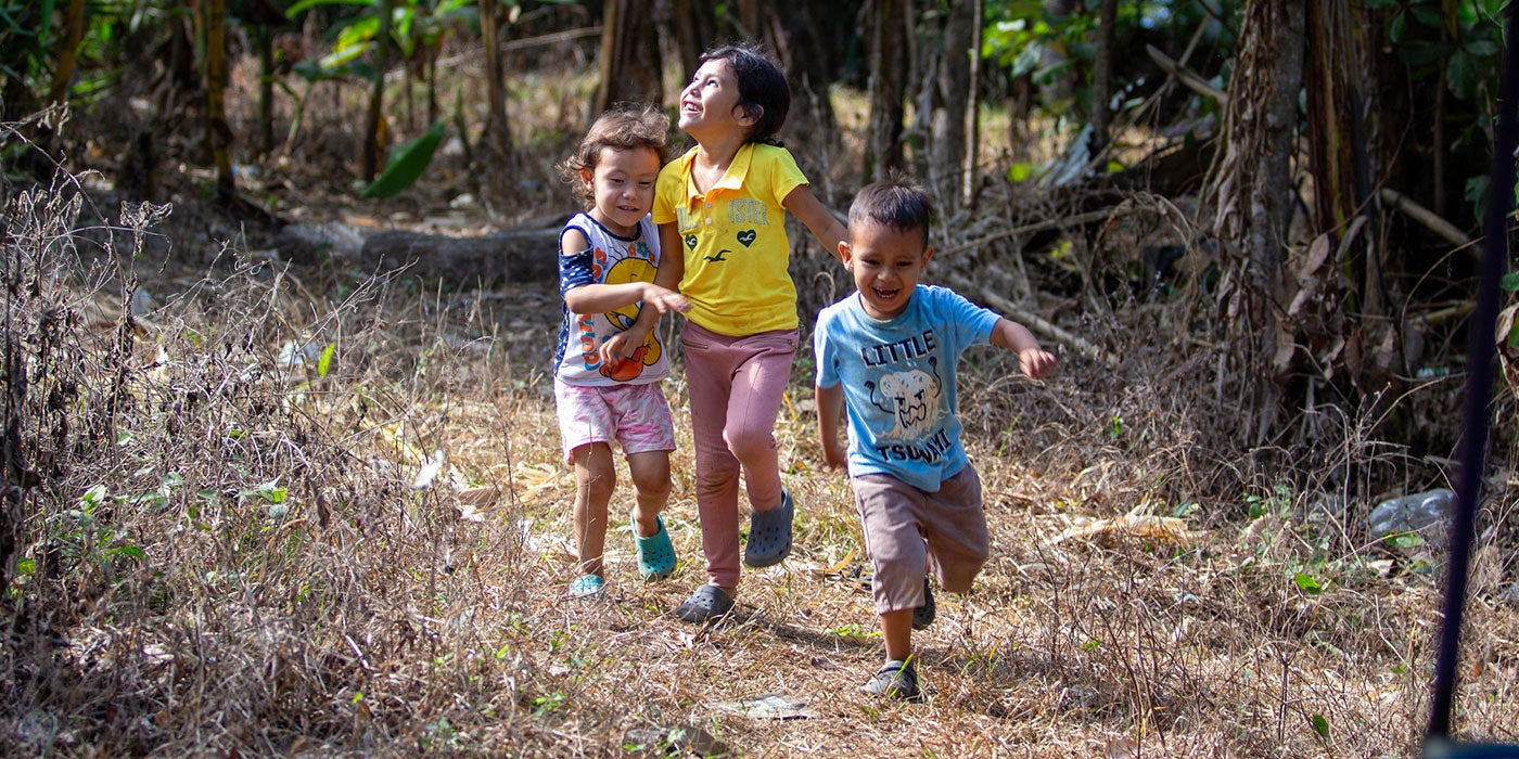 Children running on a dirt road