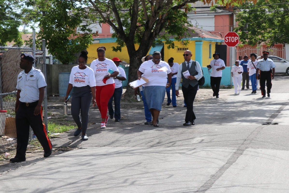 team members are walking in the Bain Town community to encourage residents to get vaccinated.