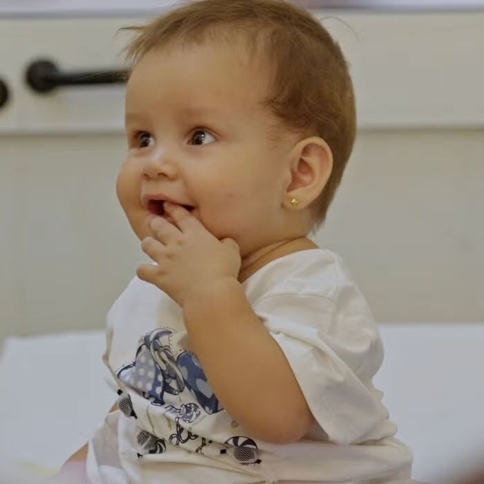 Happy baby in vaccination service