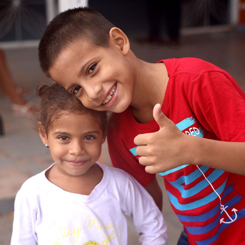 Happy boy and girl smiling to the camera