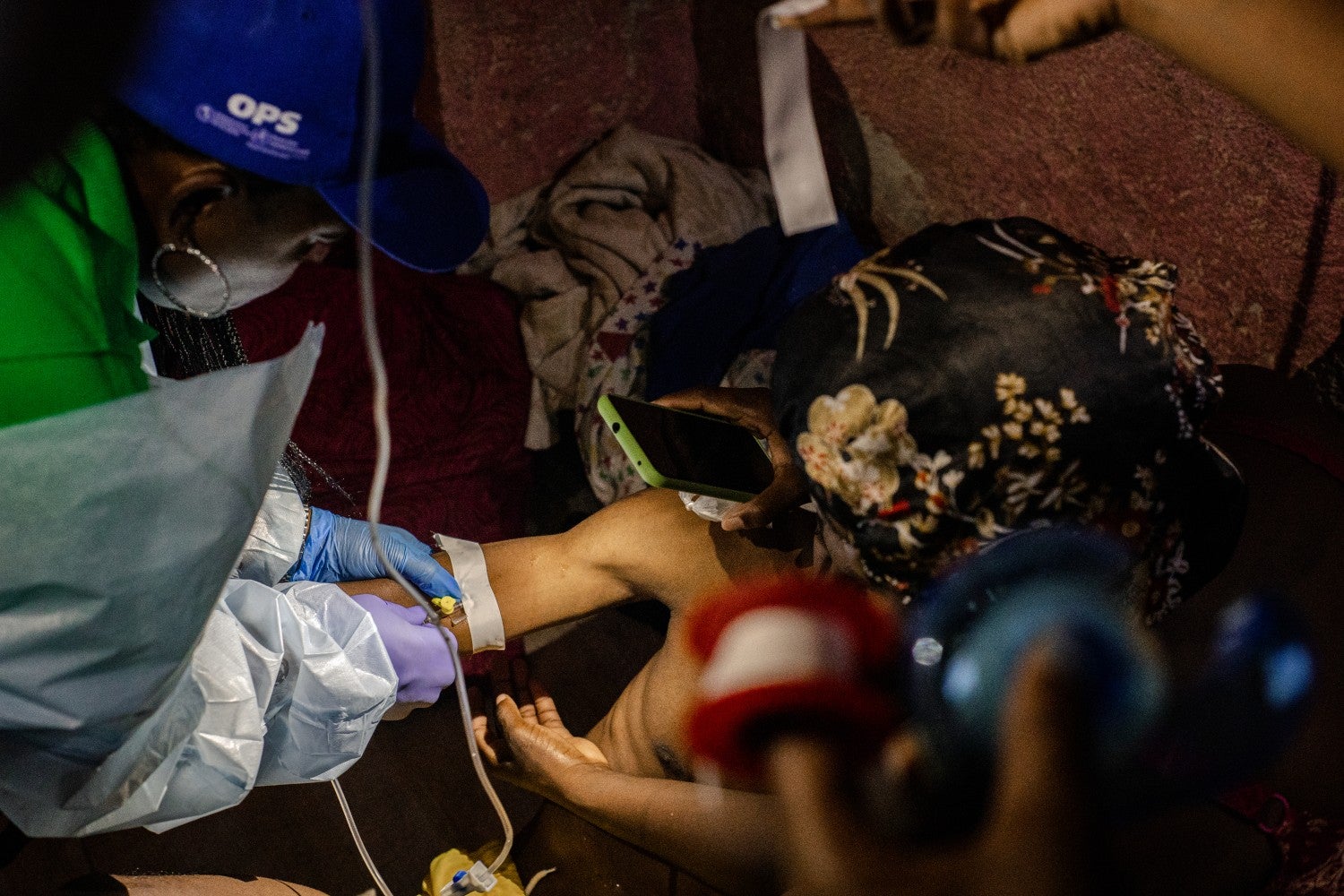 nurse inserting IV in patient's arm