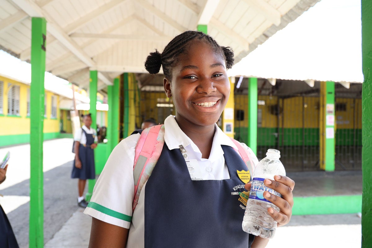 Girl chooses a water bottle over a sugary drink
