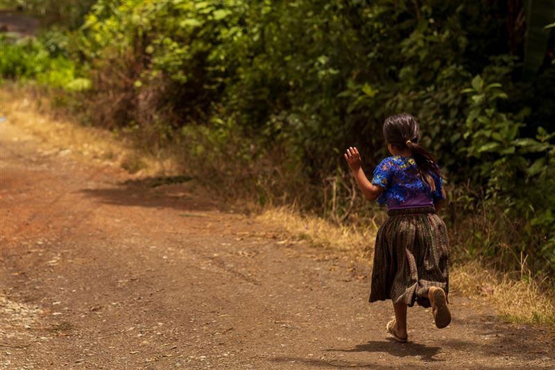 Girl running through the fields