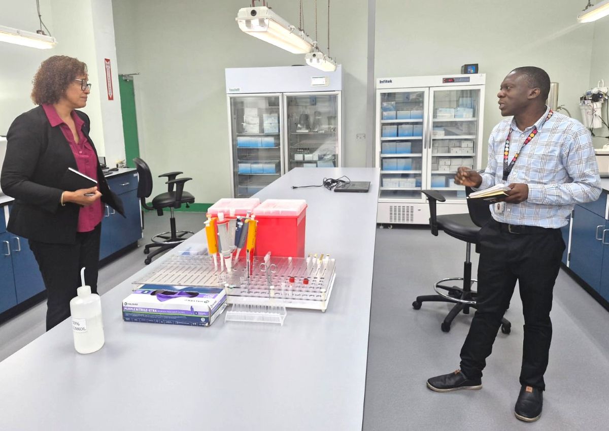 (L-R) Ms Valerie Wilson, Laboratory Expert, Caribbean MedLab Foundation in discussion with Mr. John Egunjobi , MLT III Trinidad and Tobago Blood Bank, during the visit to the Blood Bank Lab Testing Facility