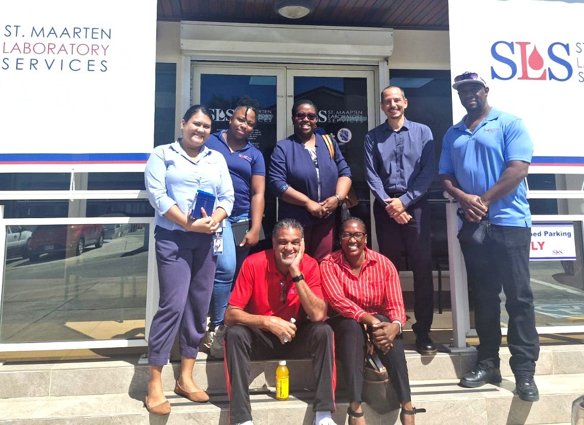 Dr. Lionel Gresh (second from right) and Dr. Shellon Bovell, Advisor - Health Systems and Services PAHO/WHO Trinidad and Tobago and Dutch Caribbean Country Office ( Back Centre) with representatives from Sint Maarten Laboratory Services