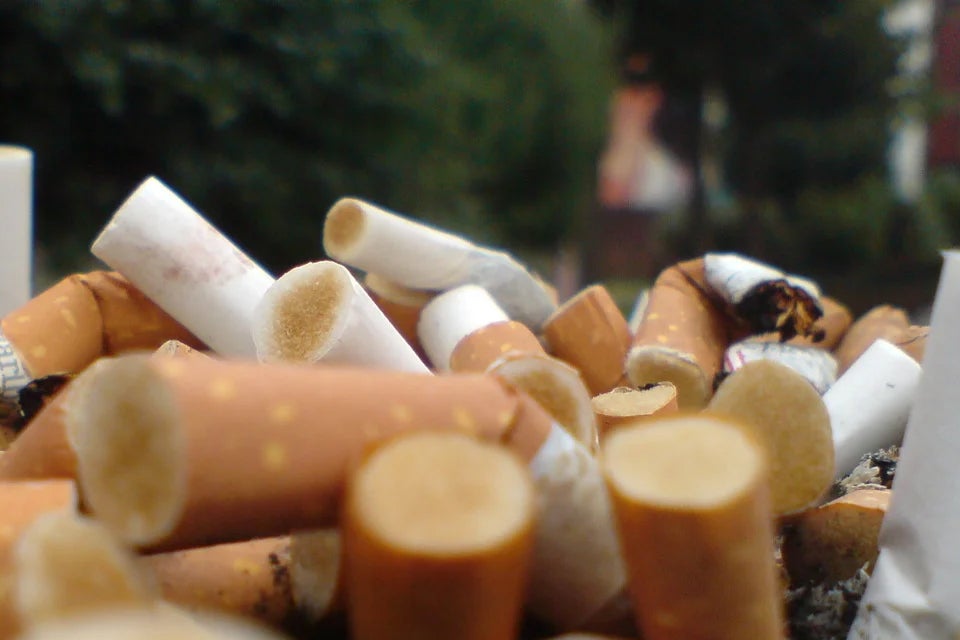 a pile of cigarette butts in the foreground