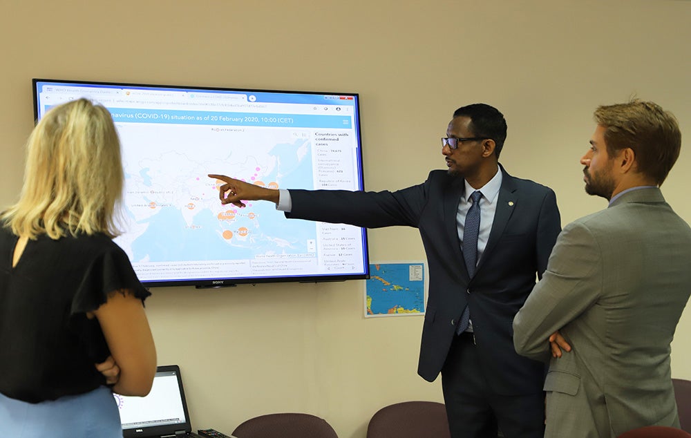 Dr Gebre guided dignitaries on the tour of the EOC. In this photo he explains the WHO COVID-19 situation dashboard to the Deputy High Commissioner of the New Zealand Commission and Deputy Head of Mission of the Brazil Embassy.