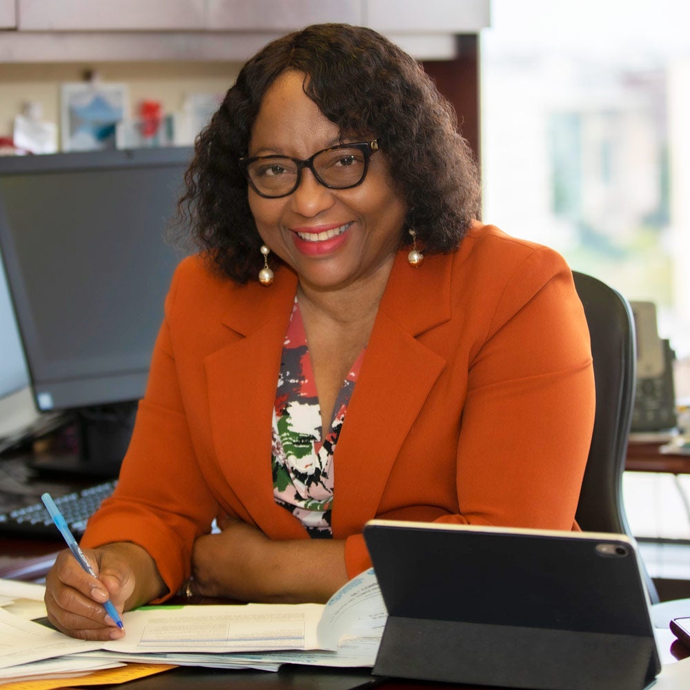 Dr. Etienne at her desk