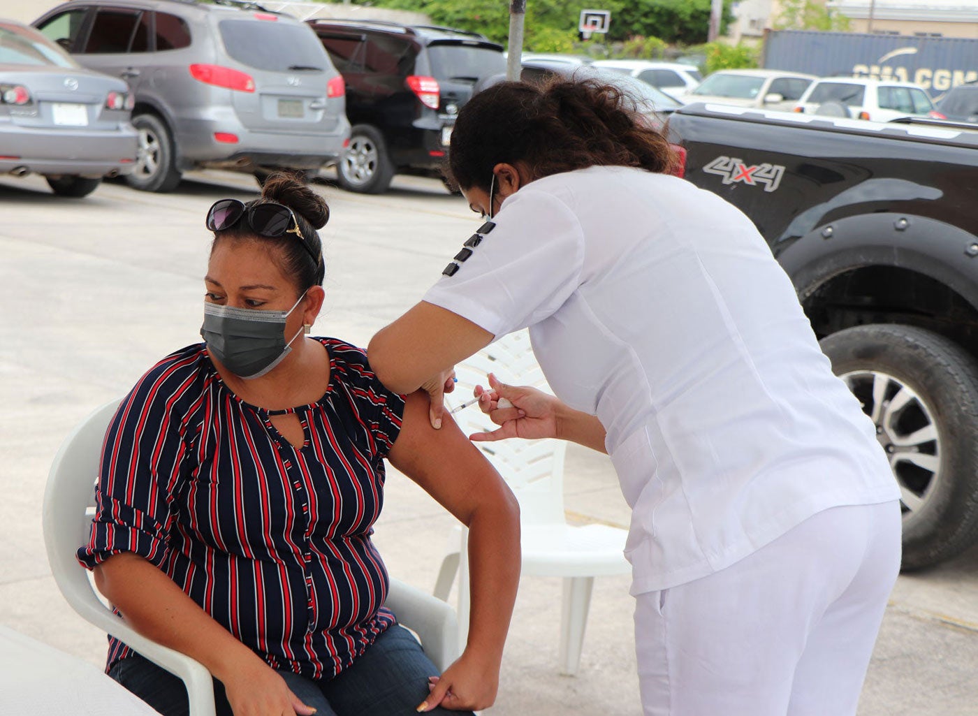 Karima Vasquez receiving flu vaccine at PAHO/WHO Belize Vaccination Drive