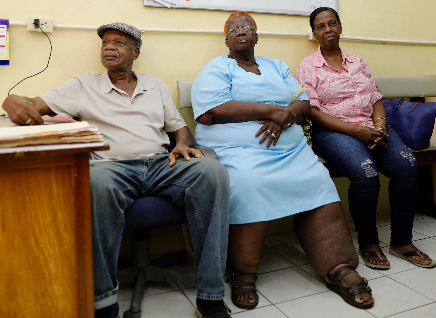 Woman with lymphatic filariasis waits in doctor's office.