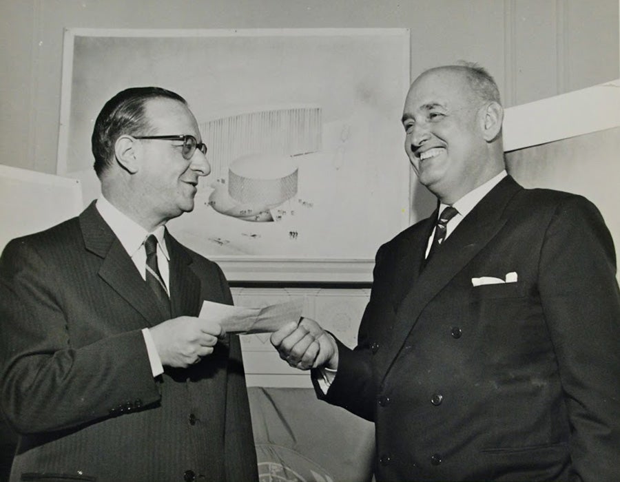 Headquarters architect Román Fresnedo Siri, right, accepts $ 10,000 competition-winning check from Director, Dr. Abraham Horwitz