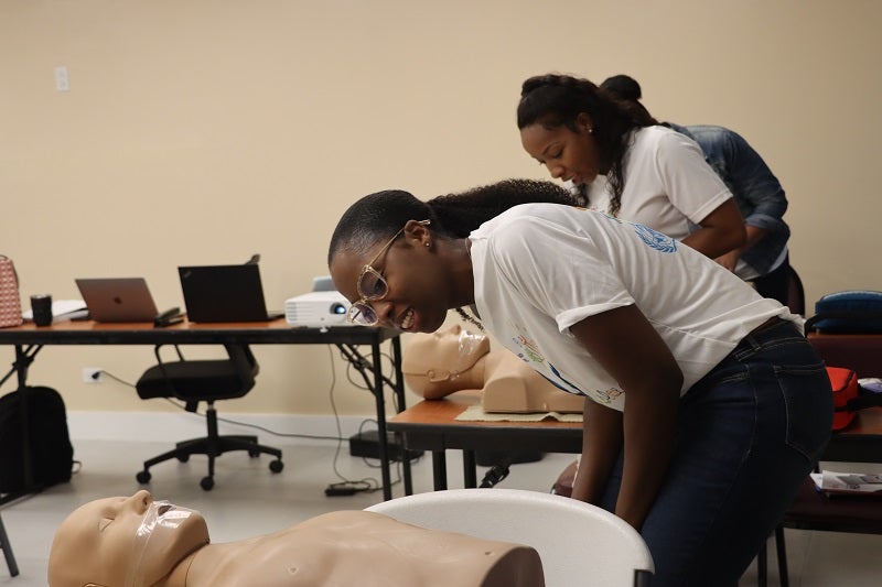 PAHO/WHO Panthers practice looking for breaths before administering CPR.