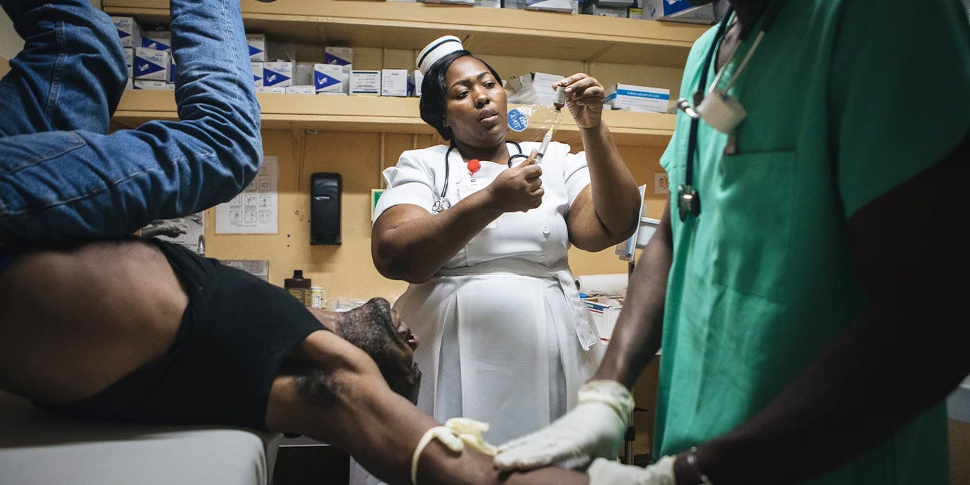 Jamaican emergency nurse responding to patient crisis 