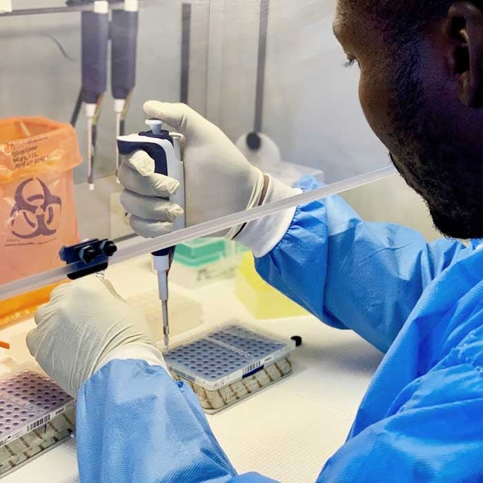 Lab technician in Haiti preparesDNA samples. 