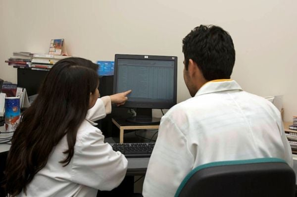 lab technicians looking at a screen