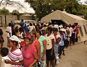 Haitians stand in line to get food and other supplies