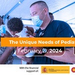 A mother and a frist responder holds a baby inside a hospital