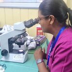 Person looking through a microscope