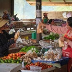 Women interacting in an open market