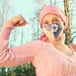 Woman making gesture indicating fighting against cancer