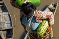 Woman with watermelons and fish in hand