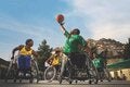 Group of young men playing basketball on wheel chairs