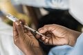 Health workers holds COVID-19 vaccine