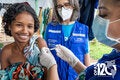 Criança sorrindo recebendo a vacina