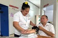 Patient at health centerchecks his blood pressure