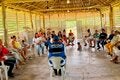 personas indigenas escuchando a personal de OPS