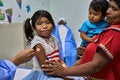 Siblings get vaccinated in las Garzas Health Center in Panama