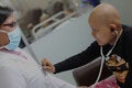 child with cancer interacting with doctor