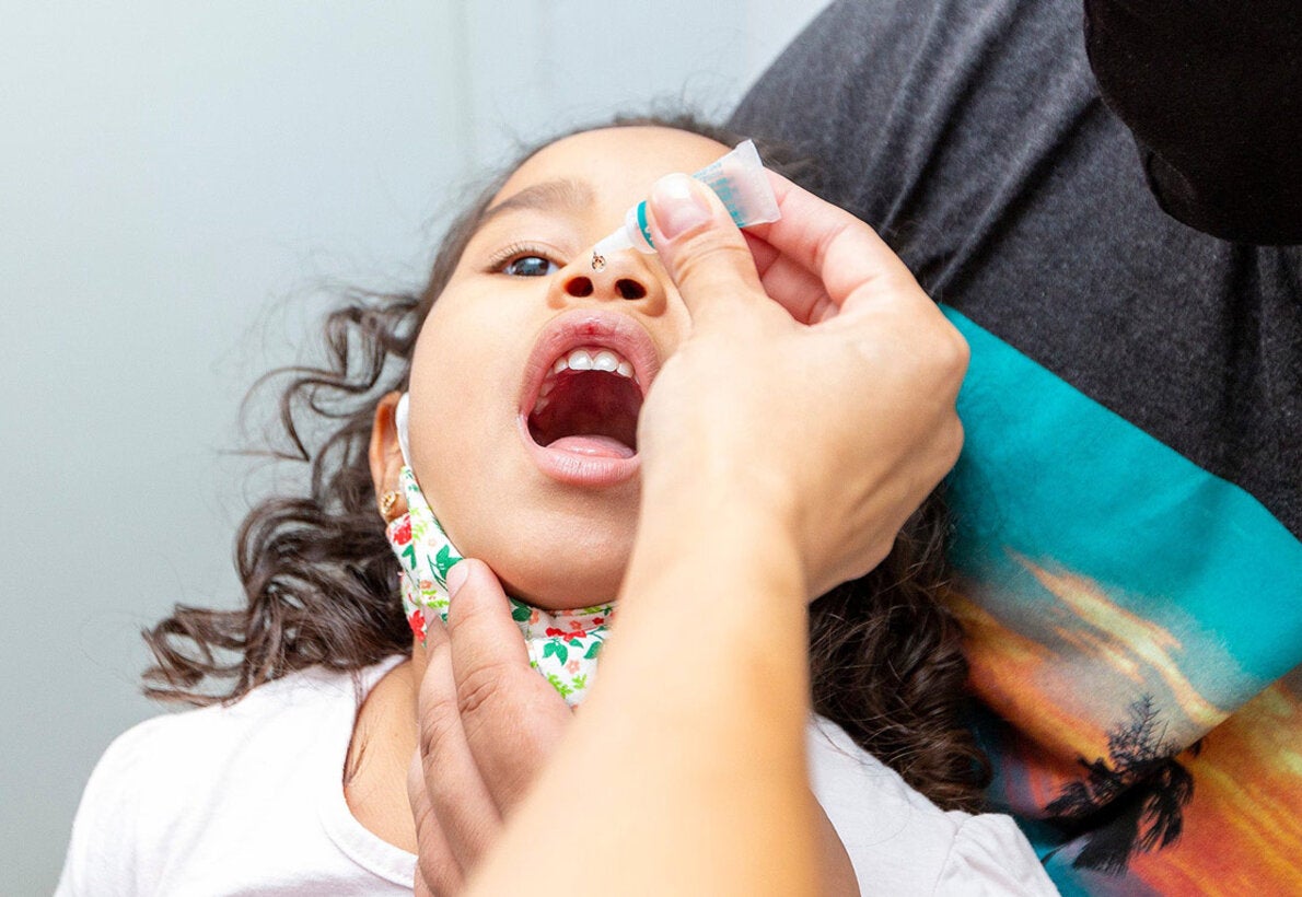 girl receiving polio vaccine