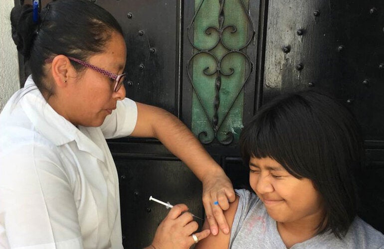 Girl being vaccinated