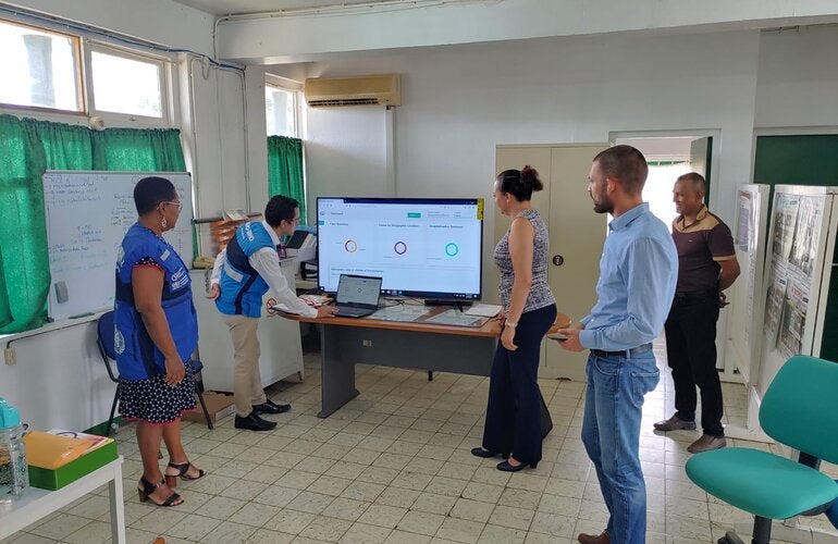 Dr. Cleopatra Jessurun, Director of Public Health being trained on key features of the Go.Data system with support from BOG, PAHO and IDB staff