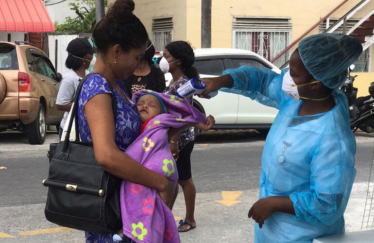 health worker taking temperature