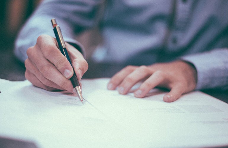 Man editing white paper 