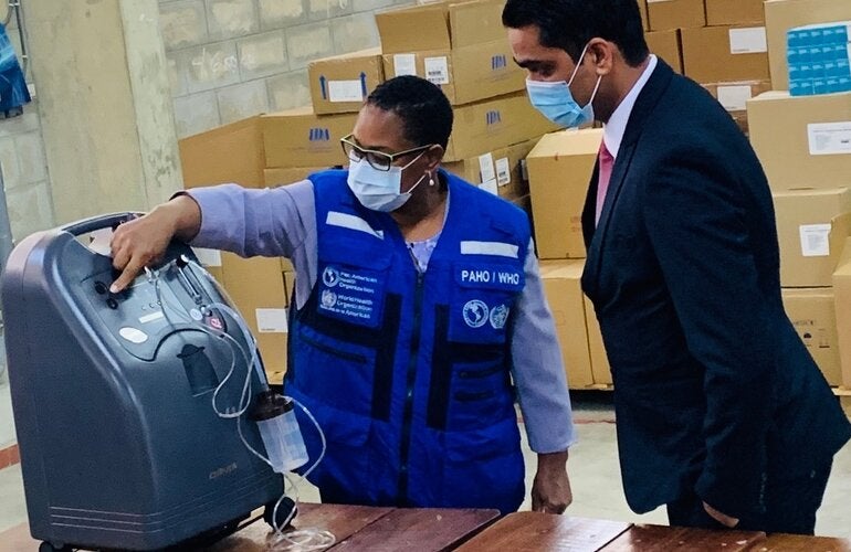PAHO/WHO Representative for Suriname, Dr. Karen Lewis-Bell officially hands-over 20 oxygen concentrators to Dr. Amar Ramadhin, Minister of Health.