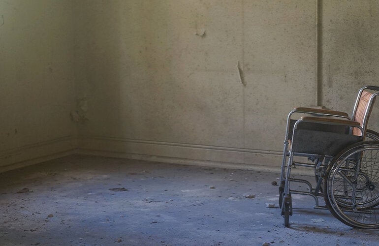 Abandoned wheelchair in hospital room