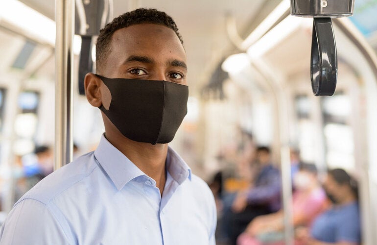 Man wearing mask using public transportation