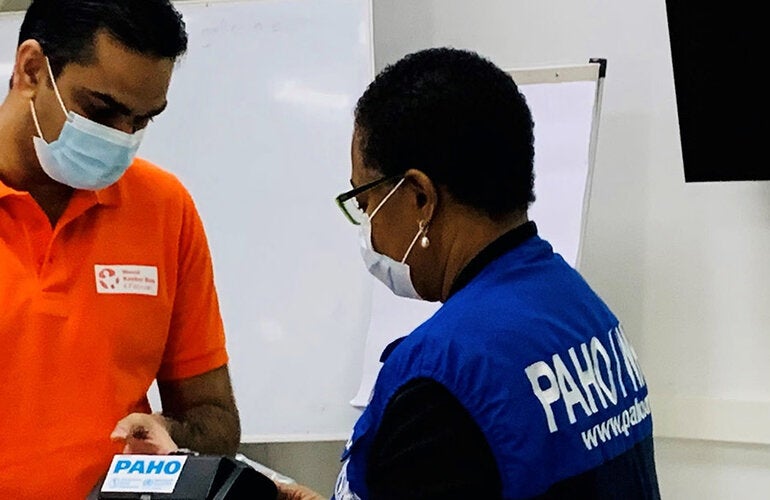 Minister Ramadhin and Dr. Lewis-Bell inspect the biPAP machines at the official handover